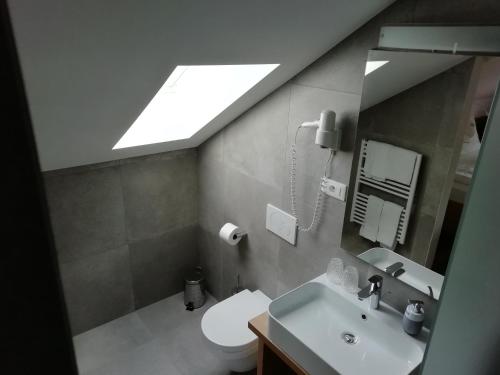 テルラーノにあるPension Runerのバスルーム(トイレ、シンク、天窓付)