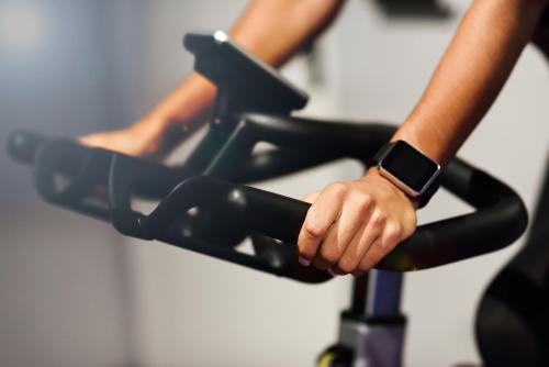 a woman is riding on an exercise bike at Viaggio Urbano Business in Bogotá