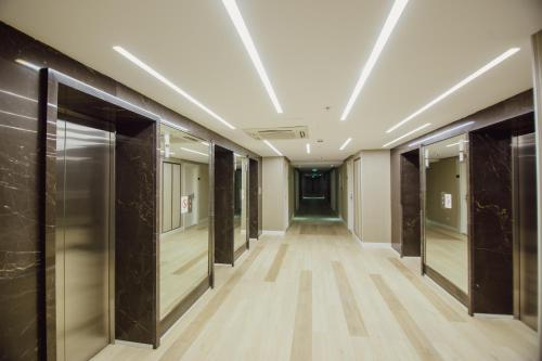 a corridor of an office building with glass doors at My Sunshine Apartments in Batumi in Batumi