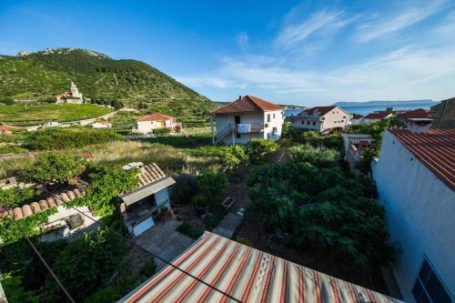 an overhead view of a village with houses and trees at Garden Apartments in Komiža