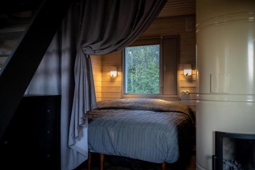 a bedroom with a bed and a window at Hiiumaa Summerhouse in Orjaku