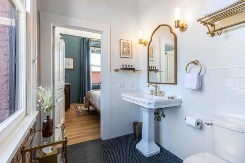 a bathroom with a sink and a toilet and a mirror at National Exchange Hotel in Nevada City