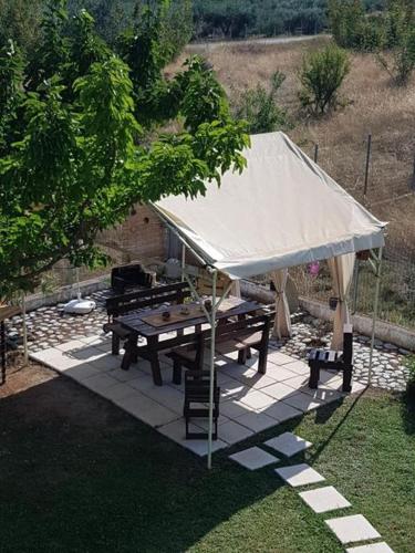 a tent with a picnic table and a grill at Plaka Luxury Villa in Litochoro