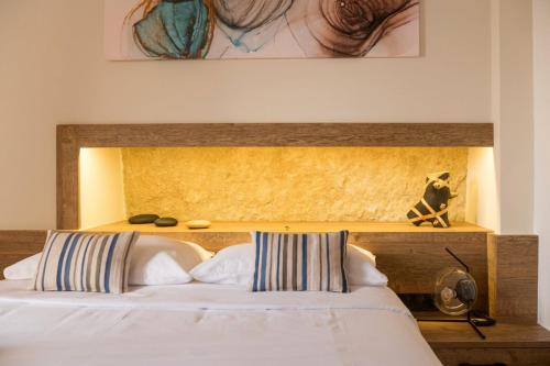 a bedroom with a bed with a wooden headboard at MATALA * LUX CAVE in Matala