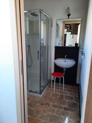 a bathroom with a glass shower and a sink at Casale Oasi in Pozzallo