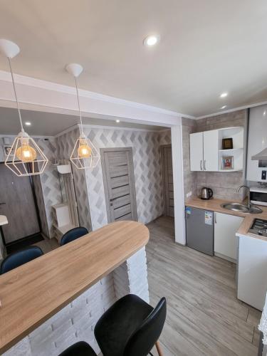a kitchen and dining room with a table and chairs at Danyla Galytskogo apartment Центр міста, старе місто 5хв in Kamianets-Podilskyi