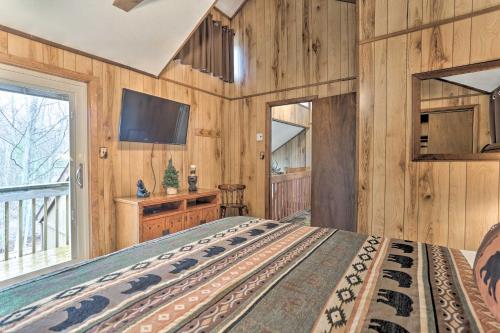 a bedroom with wooden walls and a large bed at Game Room and Golf Cart Bear Den Pocono Lake Home in Pocono Lake