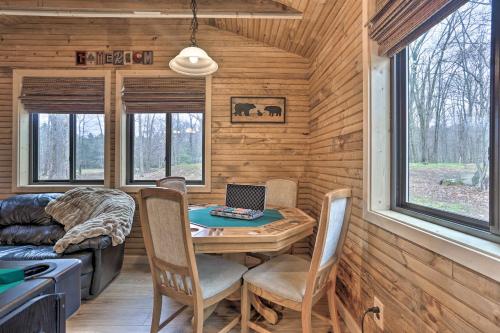 a tiny house with a table and chairs and a laptop at Game Room and Golf Cart Bear Den Pocono Lake Home in Pocono Lake