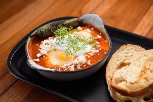 a plate of food with a bowl of soup and a sandwich at Diez Diez Collection in Mérida