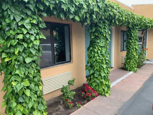 a building with green ivy on the side of it at Monterey Oceanside Inn in Monterey
