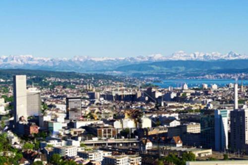 an aerial view of a city with buildings at Turicum Apartment mit Balkon und Parkplatz in Zürich