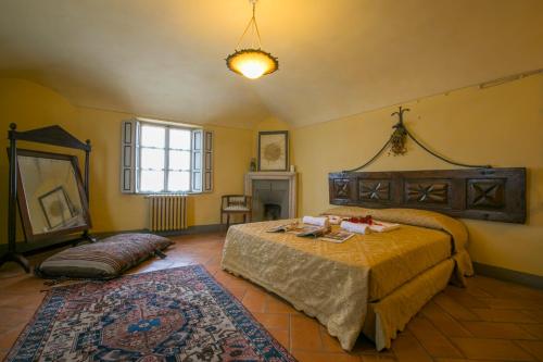 a bedroom with a large bed and a rug at Palazzo Tornielli in Mombello Monferrato