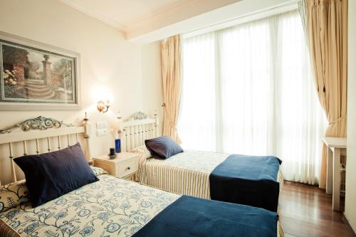 Postel nebo postele na pokoji v ubytování Hotel Fonte de San Roque