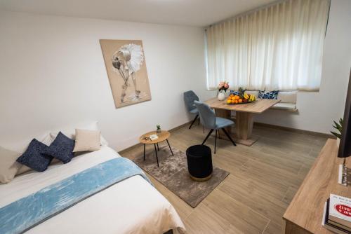 a bedroom with a bed and a desk and a table at N & D in Šibenik