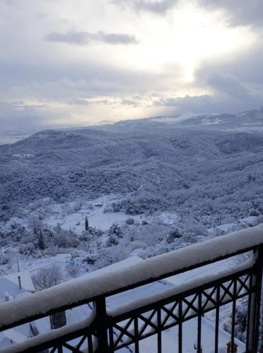 a view of a snow covered valley with a fence at Hotel Isaraiko Spiti Agia Theodora in Isaris