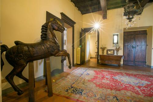 a statue of a horse on a stand in a room at Palazzo Tornielli in Mombello Monferrato