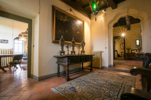 a room with a table and a painting on the wall at Palazzo Tornielli in Mombello Monferrato