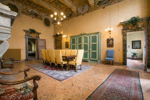 a dining room with a table and chairs at Palazzo Tornielli in Mombello Monferrato
