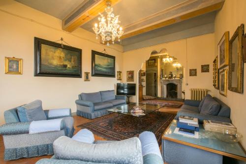 a living room with blue furniture and a chandelier at Palazzo Tornielli in Mombello Monferrato