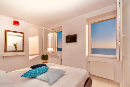 a bedroom with a bed with a view of the ocean at Lucy's House in Riomaggiore