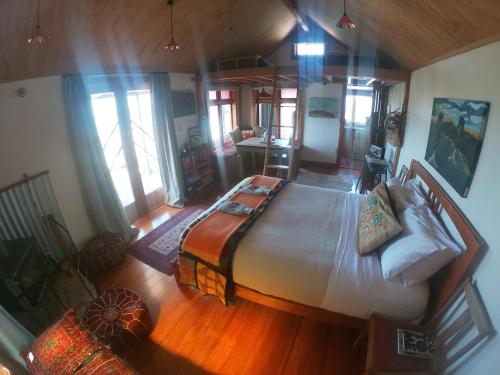 a bedroom with a large bed in a room at Rock Retreat B&B farmstay in Waitomo Caves
