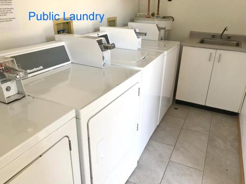a kitchen with white cabinets and a sink at Duncan Motel in Duncan