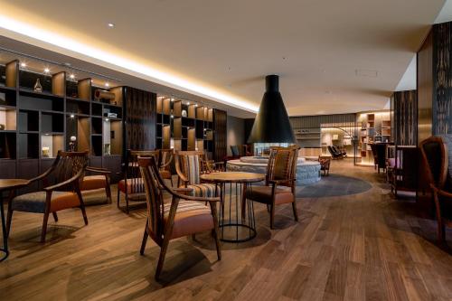 a restaurant with tables and chairs in a room at Shogetsu Grand Hotel in Jozankei
