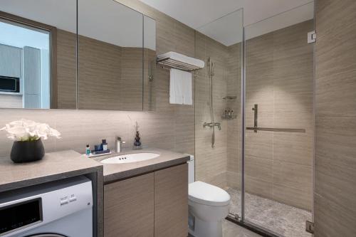 a bathroom with a shower and a toilet and a sink at Star Residence ICC Guangzhou in Guangzhou
