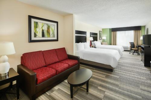a hotel room with a couch and a bed at Holiday Inn Express & Suites I-26 & Us 29 At Westgate Mall by IHG in Spartanburg