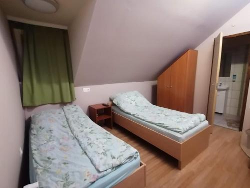 a bedroom with two beds and a window in it at Silver Horse Ranch in Békés