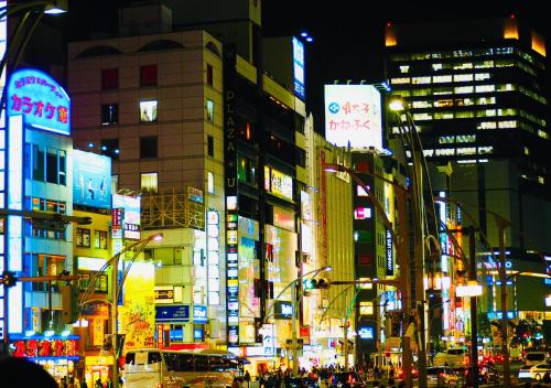 a busy city street at night with many buildings at APA Hotel Ueno Ekimae in Tokyo