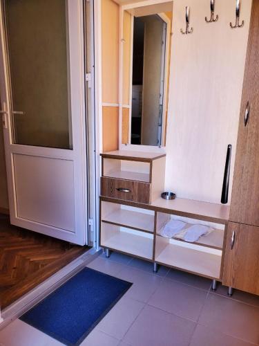 a bathroom with a vanity with a mirror and a door at Апартаменти "Ілона" в центрі Східниці in Skhidnitsa