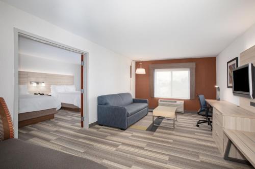 a hotel room with a bed and a chair at Holiday Inn Express Ontario by IHG in Creekside