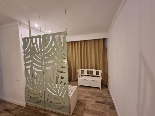 a room with a sliding glass door with a crib at Hotel Sunrise in Crisan