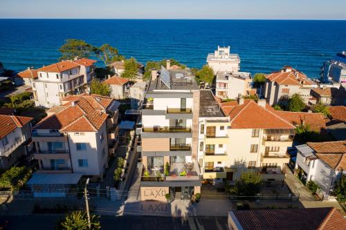 an aerial view of a city with houses and the ocean at Family Hotel LAXO in Obzor