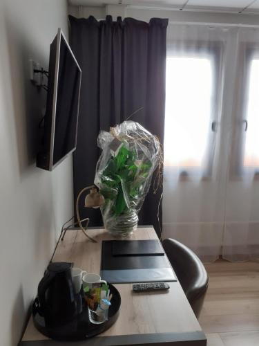 a table with a vase on top of it at Hotell Greven in Vårgårda