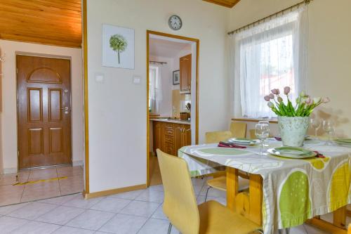a kitchen and dining room with a table and chairs at Apartament u Ani 1 in Dźwirzyno