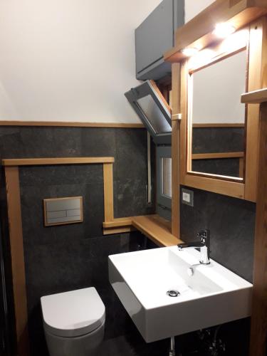 a bathroom with a white sink and a toilet at Hotel Florian in Nus