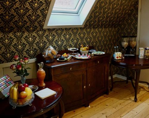 a room with a table with food on it at Old Roses Guesthouse in Broager