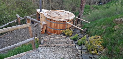 a large wooden barrel sitting on top of a hill at Domek Gabi z balią w ogrodzie in Zakopane