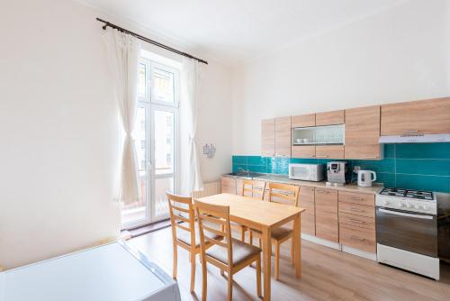 eine Küche mit einem Holztisch und Stühlen in der Unterkunft Spacious Apartment Děčín in Děčín