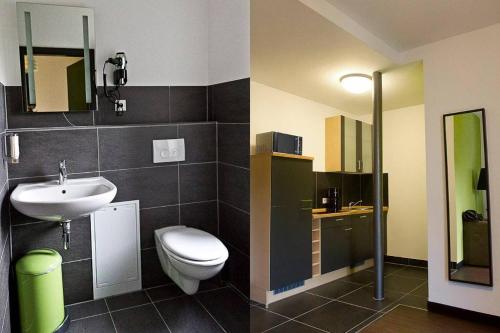 a bathroom with a toilet and a sink at 1,5 Zimmer City-Apartment-Bielefeld in Bielefeld