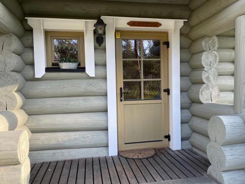 a front door of a house with a window at Kasepuu Holiday House in Uulu