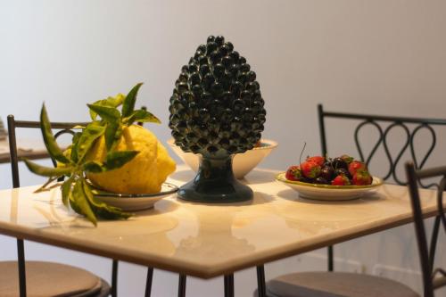 a table with two bowls of fruit on it at B&B Nicotera29 in Vico Equense