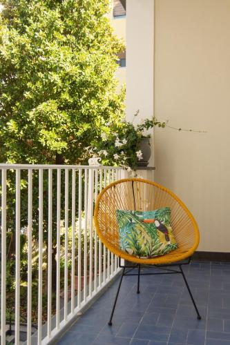 a wicker chair with a pillow on a porch at B&B Nicotera29 in Vico Equense
