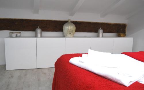 a white bedroom with a red blanket and white cabinets at Tourist House Bologna - Self check-in in Bologna