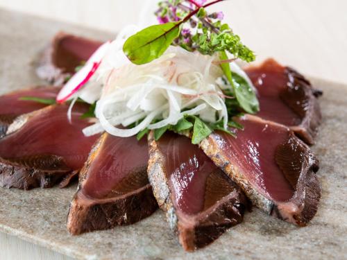 a piece of meat with a salad on top of it at ART HOTEL Miyazaki Sky Tower in Miyazaki