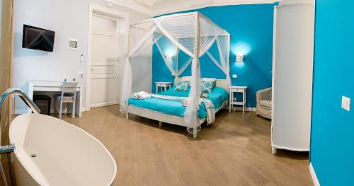 a blue bedroom with a bed with a canopy at B&B Carella in Palermo