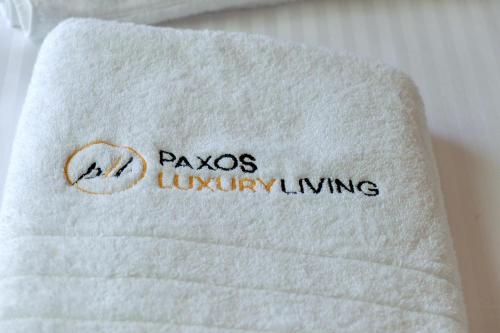 a towel with the name parsos luxury living on it at Paxos Luxury Living Junior Suites in Gaios