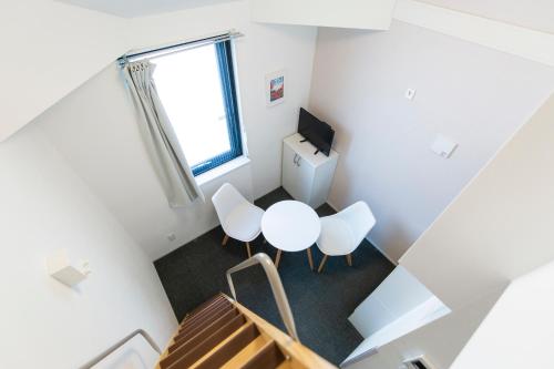 una vista aérea de una habitación con mesa y sillas en GLOU Higashi Shinjuku en Tokio